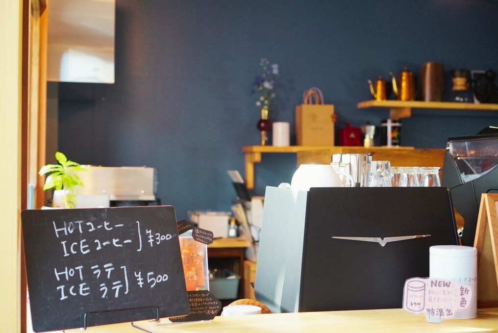 ブルーの壁紙がおしゃれなコーヒースタンドでは美味しいコーヒーを地元の人々へ届けている